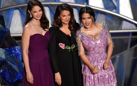 Ashley Judd, from left, Annabella Sciorra and Salma Hayek speak at the Oscars  - Credit: AP