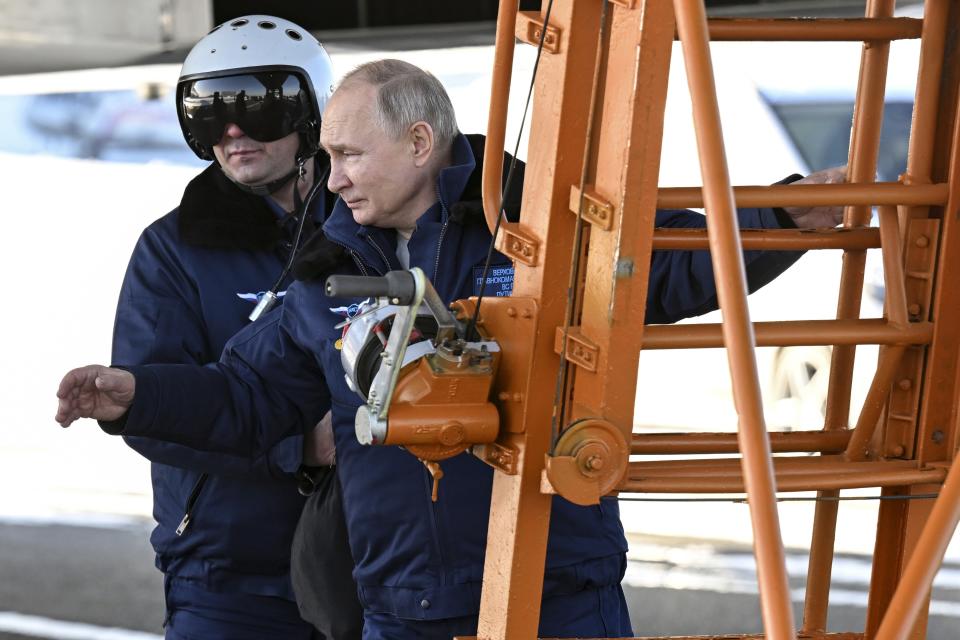 Russian President Vladimir Putin, foreground, boards a Tu-160M strategic bomber in Kazan, Russia, Thursday, Feb. 22, 2024. (Dmitry Azarov, Sputnik, Kremlin Pool Photo via AP)