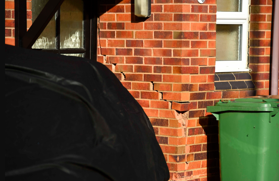 Bricks were left falling off the property following the JCB attack. (Wales News Service)