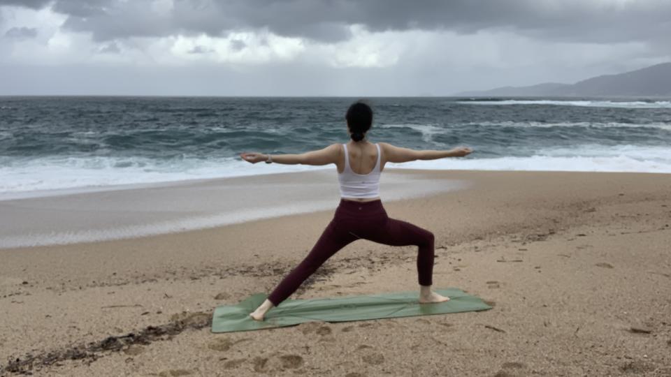 Woman doing yoga on the beach