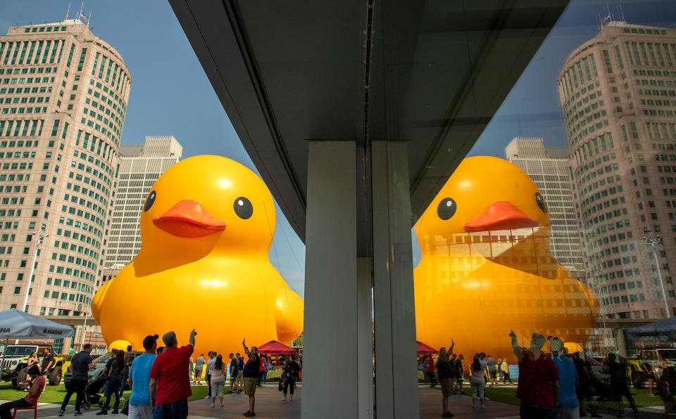 Crowds stop to take photos of the 61 foot-tall duck during the 2022 North American International Auto Show Charity Preview at Huntington Place in Detroit on Saturday, September 17, 2022.