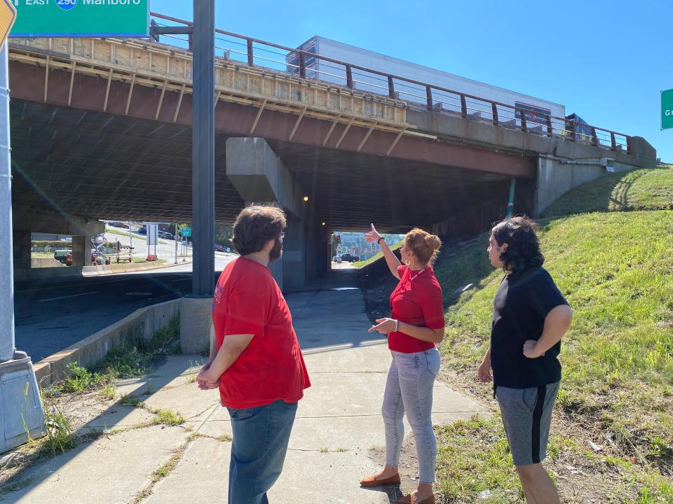 From right, Brian Mulhearn, Nelly Medina and Andy Saltzberg stand in front of the bridge passing over East Central Street, looking at the ongoing repair work.