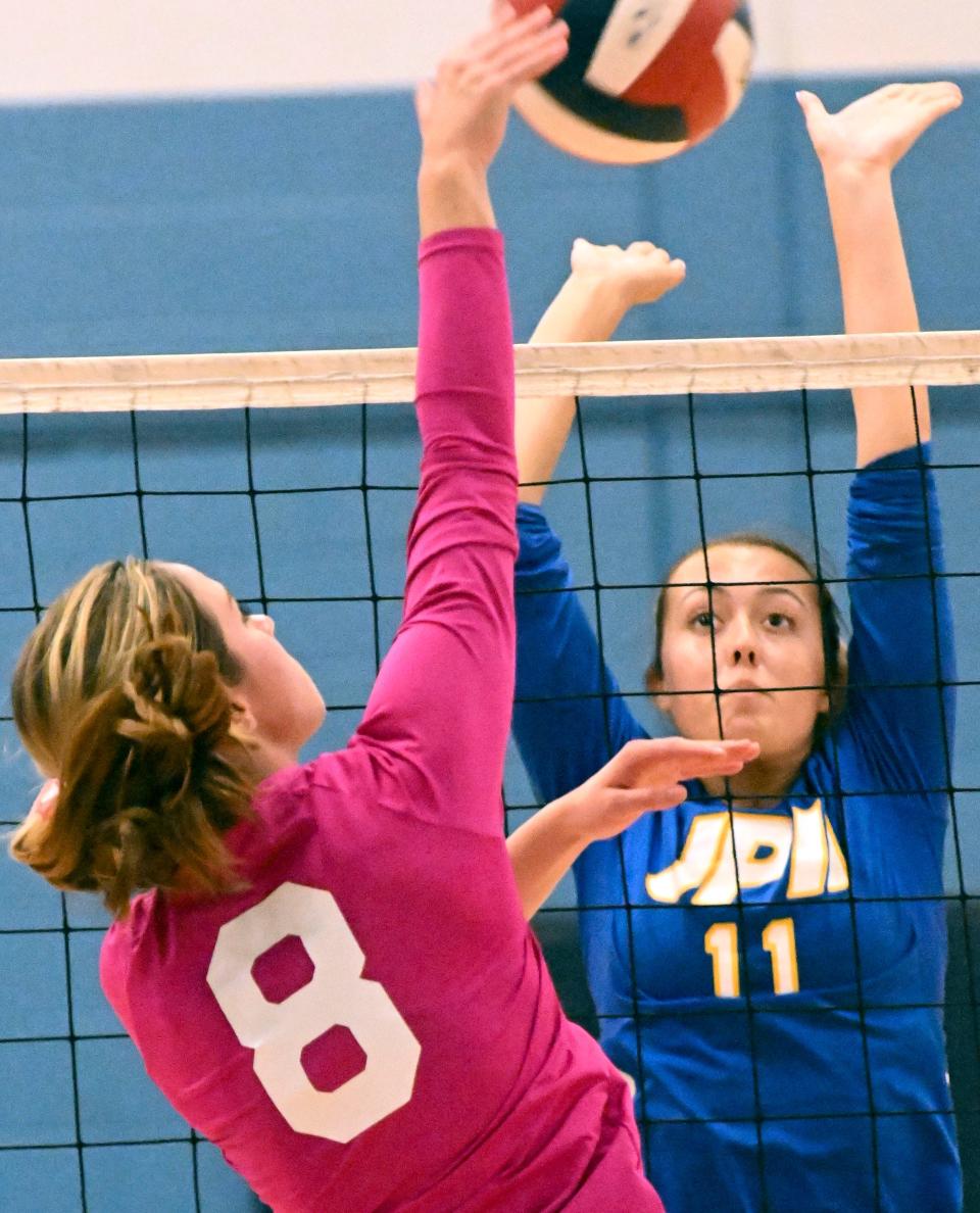 Charlotte Sturgis of St. John Paul II attempts to block a spike by Sammy Johnson of Sandwich in this Oct. 24 game in Sandwich.