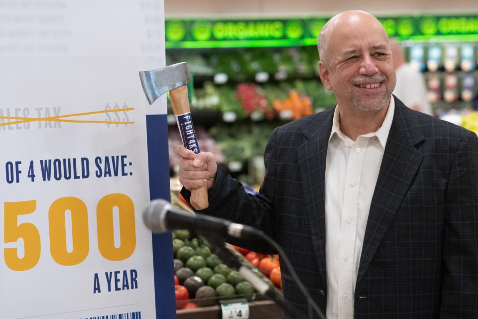Rep. Tom Sawyer, D-Wichita, poses for a photo following Monday's announcement of the "axe the food tax" campaign.