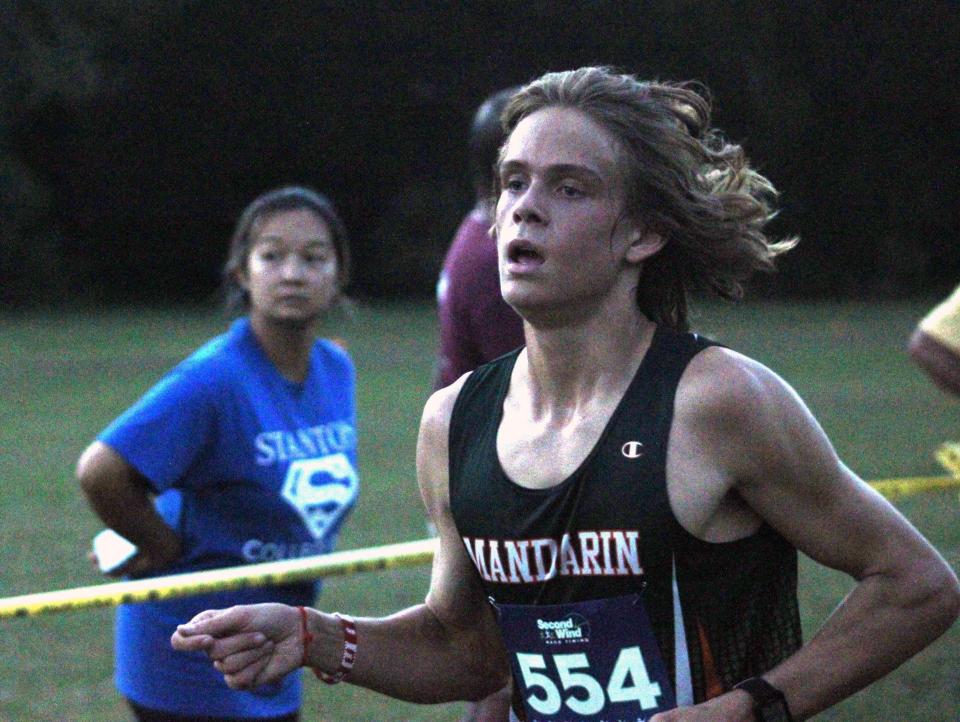 Mandarin's Gavin Nelson (554) races to the finish line to win the Gateway Conference boys cross country championship on October 13, 2021. [Clayton Freeman/Florida Times-Union]