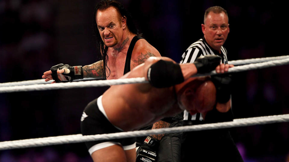 The Undertaker competes against Goldberg during the Super Showdown. (Photo by AMER HILABI/AFP/Getty Images)