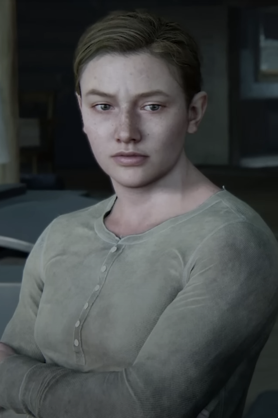 Abby from The Last of Us video game, in a serious pose, wearing a henley shirt