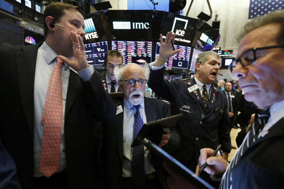 New York Stock Exchange Floor Governor Brendan Connolly, left, works with traders Peter Tuchman, John Panin and Sal Suarino, second left to right, on the floor of the NYSE, Monday, March 9, 2020. The Dow Jones Industrial Average plummeted 1,500 points, or 6%, following similar drops in Europe after a fight among major crude-producing countries jolted investors already on edge about the widening fallout from the outbreak of the new coronavirus. (AP Photo/Richard Drew)