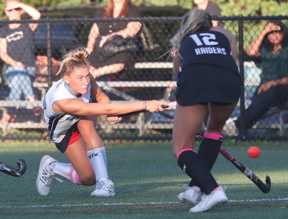 From left, UrsulineÕs Paige Moretti (13) fires a shot in front of ScarsdaleÕs Skylar Matusz (12) during field hockey action at The Ursuline School in New Rochelle Oct. 3, 2023. The teams played to a 1-1 tie.