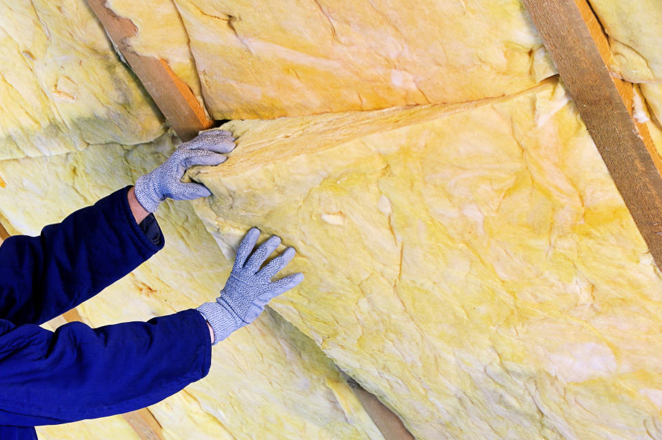 Installing insulation in an attic. (Getty Images)