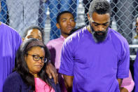 Shoshana Boyd (L) and Olympic sprinter Tyson Gay stand surrounded by those gathered during a candlelight vigil at Lafayette High School for their daughter Trinity Gay, who died in an exchange of gunfire early Sunday morning, in Lexington, Kentucky, October 17, 2016. REUTERS/Bryan Woolston