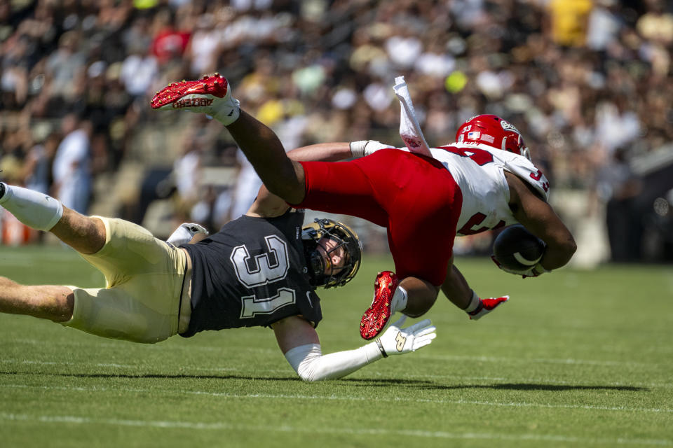 FILE - Purdue defensive back Dillon Thieneman (31) stops a run by Fresno State running back Elijah Gilliam (33) during an NCAA football game on Saturday, Sept. 2, 2023, in West Lafayette, Ind. (AP Photo/Doug McSchooler, File)