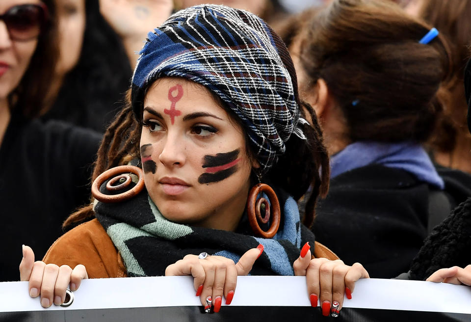 <p>A woman with a Venus symbol for female painted on her forehead takes part in a demonstration to mark the International Day for the Elimination of Violence Against Women in Rome on Nov. 25, 2017. (Photo: Tiziana Fabi/AFP/Getty Images) </p>