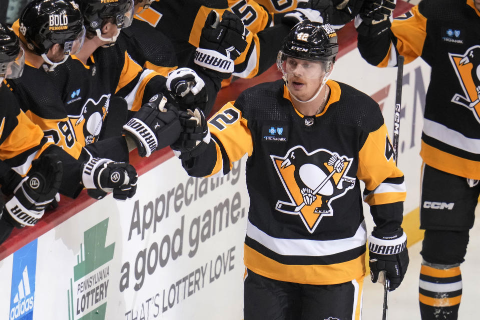 Pittsburgh Penguins' Kasperi Kapanen (42) returns to the bench after scoring the first of his two goals against the St. Louis Blues during the first period of an NHL hockey game Saturday, Dec. 3, 2022. (AP Photo/Gene J. Puskar)