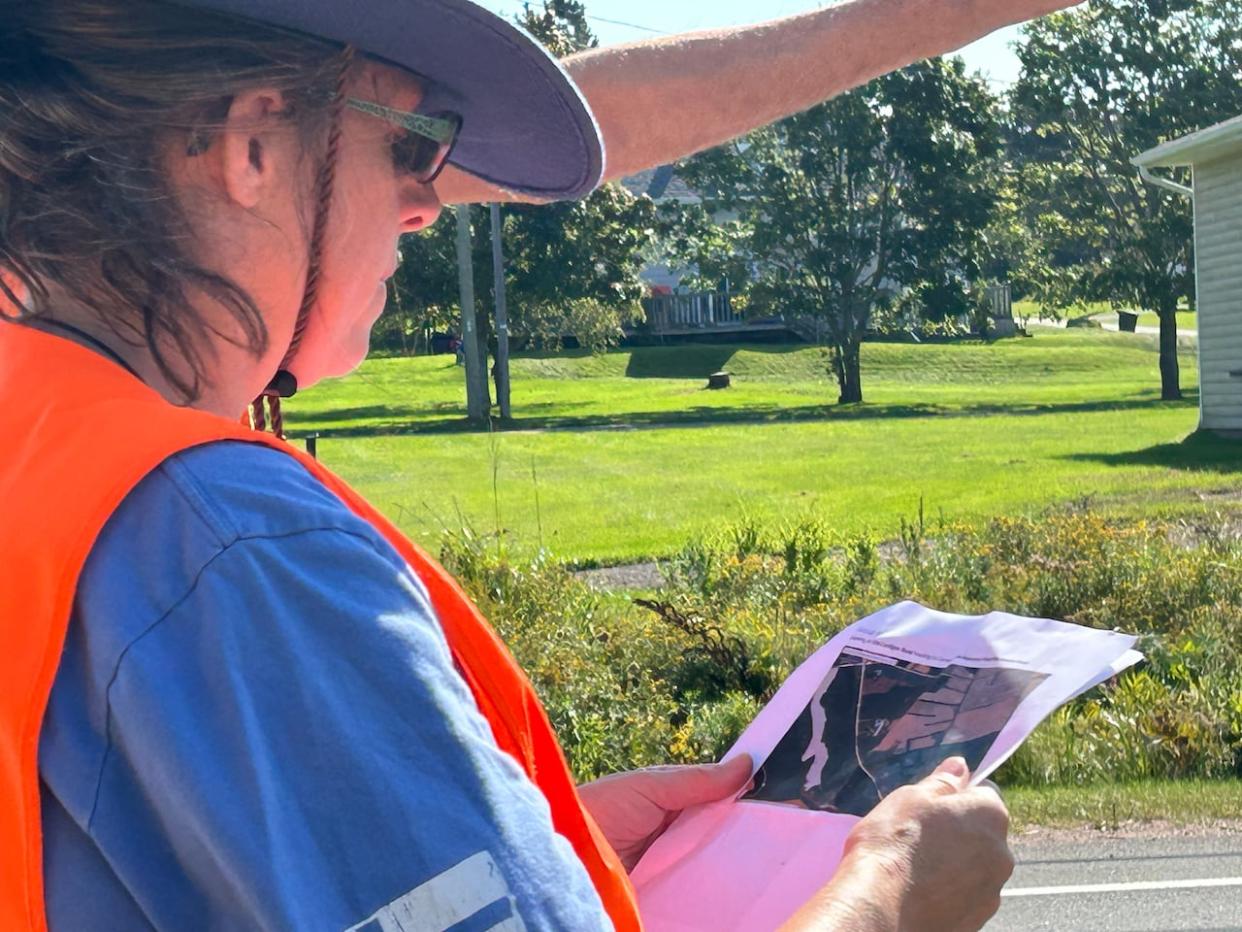 A volunteer holds a map of the Mount Stewart area, which was being searched for signs of Summer Kneebone on Tuesday. (Stacey Janzer/CBC - image credit)