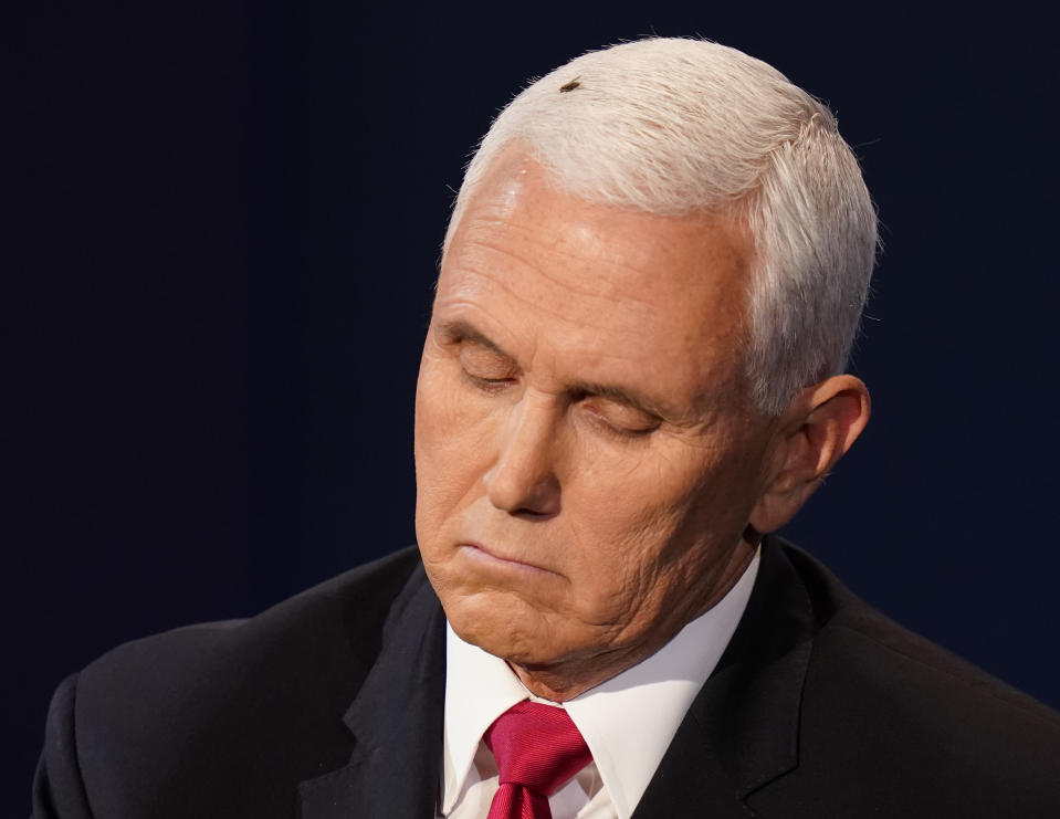 Vice President Mike Pence listens to Democratic vice presidential candidate Sen. Kamala Harris, D-Calif., during the vice presidential debate Wednesday, Oct. 7, 2020, at Kingsbury Hall on the campus of the University of Utah in Salt Lake City. (AP Photo/Patrick Semansky)