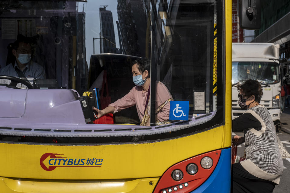 A women wearing a face mask pays with octopus as she board a bus operated by Citybus in Hong Kong, Tuesday, March 13, 2021. Today the Hong Kong Government Executive Council approve Fare Increase for Hong Kongs Major Bus Company , Citybus and New World First Bus, which are both owned by Bravo Transport, to increase fares in two phases  by 8.5 per cent from April 4 and a further 3.2 per cent on January 2 next year.KMB was allowed to raise fares by 8.5 per cent, while New Lantao Bus can charge passengers 9.8 per cent more, both effective on April 4. (Photo by Vernon Yuen/NurPhoto via Getty Images)