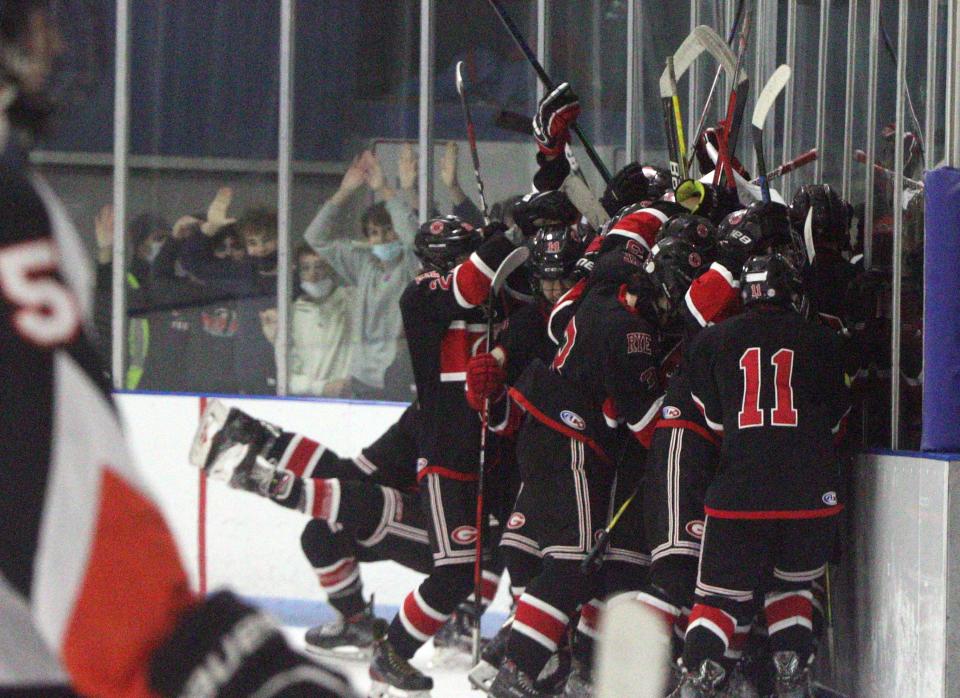 Rye players celebrate their 4-3 overtime win over Mamaroneck at Hommocks Dec. 3, 2021.