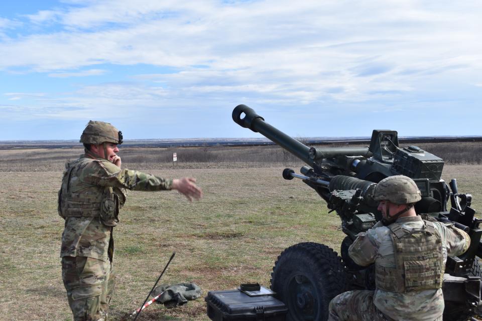 US soldiers fire the M119.