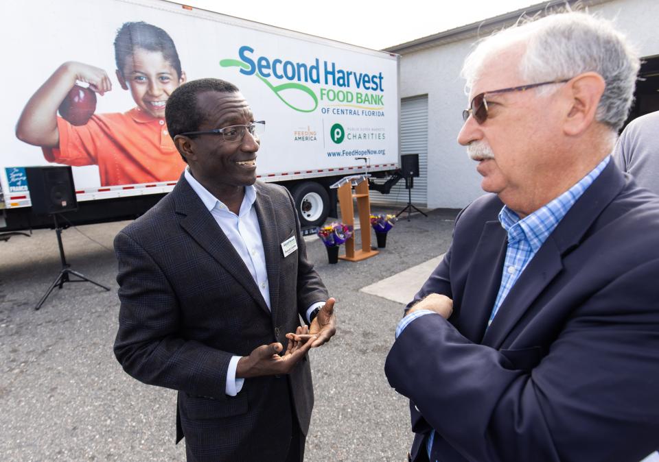 CEO Derrick Chubbs of Second Harvest Food Bank of Central Florida, left, and Bob Haight, interim president of United Way of Marion County, right, talk after a Nov. 14 press event. Second Harvest and First Step Food Bank in Ocala announced a merger that's intended to help distribute more food throughout Marion County.