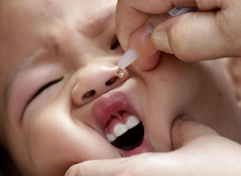 FILE - In this Friday, Sept. 12, 2014, file photo, a local health worker administers a vaccine to a baby at a local health center at the financial district of Makati, east of Manila, Philippines. The World Health Organization and the British government are working with the Philippine Department of Health, UNICEF and a host of other partners to help deliver a month-long campaign to immunize children against Measles, Rubella, commonly known as German measles and Polio which aims to immunize 13 million children nationwide. (AP Photo/Bullit Marquez, File)