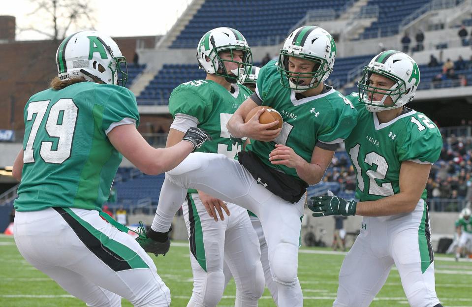 Anna quarterback Bart Bixler celebrates his first-half touchdown with teammates in the OHSAA Division VI state football final at Tom Benson Hall of Fame Stadium in Canton, Dec. 6, 2019.