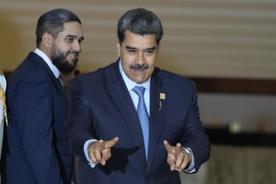 Venezuela's President Nicolas Maduro gestures to the media after attending the South American Summit at Itamaraty palace in Brasilia, Brazil, Tuesday, May 30, 2023. South America's leaders are gathering as part of Lula's attempt to reinvigorate regional integration efforts. (AP Photo/Andre Penner)