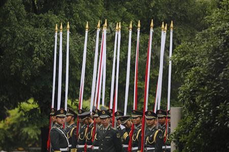 Honour guards wait for the arrival of visiting Russian President Vladimir Putin during a bilateral meeting with Chinese President Xi Jinping at Xijiao State Guesthouse, ahead of the fourth Conference on Interaction and Confidence Building Measures in Asia (CICA) summit, in Shanghai May 20, 2014. REUTERS/Carlos Barria