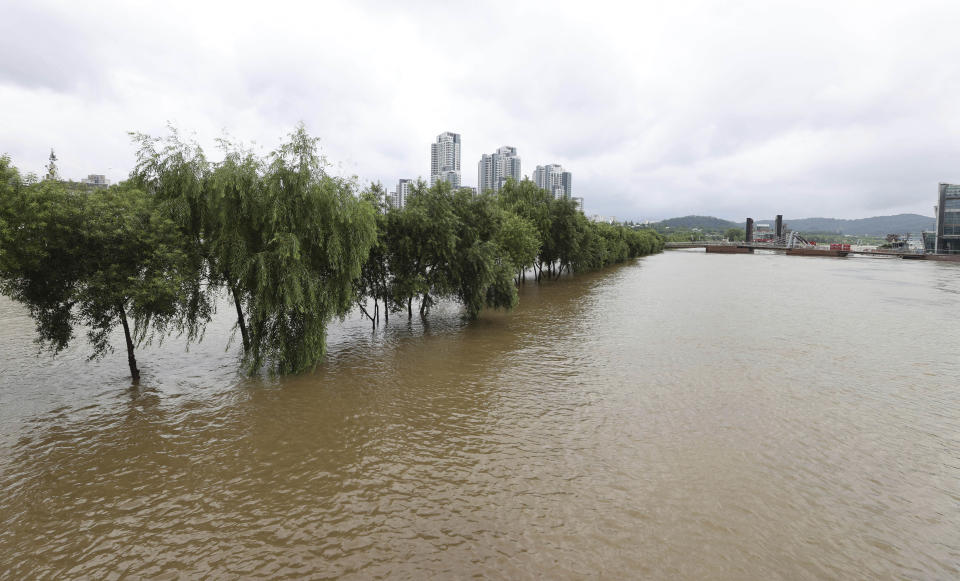 A part of a park near Han river is flooded after heavy rain in Seoul, South Korea, Sunday, Aug. 2, 2020. South Korean Meteorological Administration issued a warning of heavy rain for Seoul and central area. (Kim In-chul/Yonhap via AP)