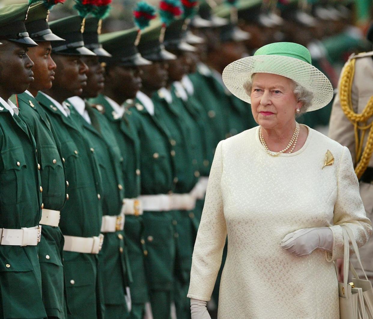 After the death of Queen Elizabeth, questions arise about whose life gets mourned and who does not. Here is the Queen with the Guards of Honour in Nigeria, Dec. 3, 2003, for the Commonwealth Heads of Government Meeting. (AP Photo/Ben Curtis)
