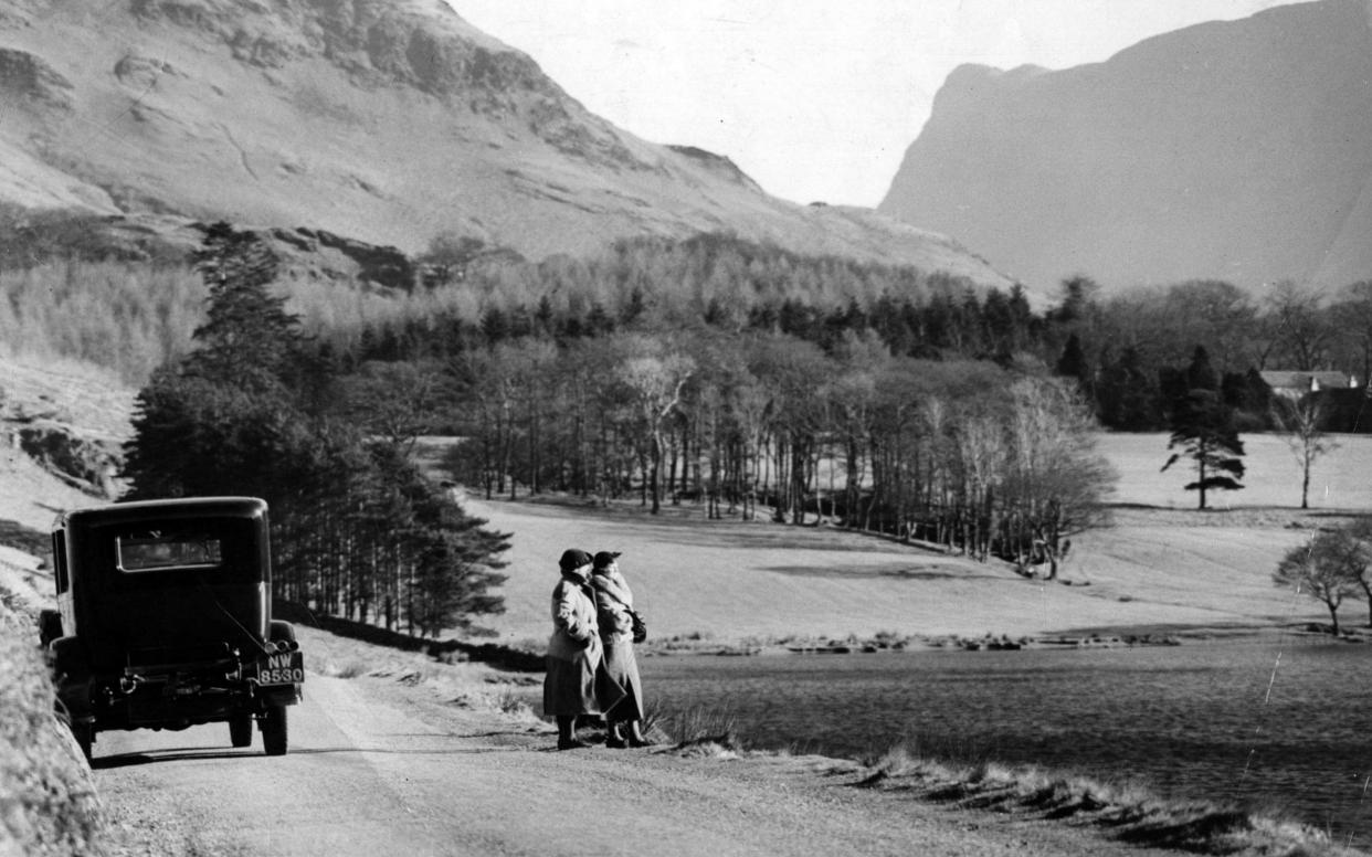 A couple look out over Crummock Water in 1929 - Getty