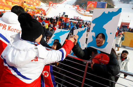 FILE PHOTO: Alpine Skiing - Pyeongchang 2018 Winter Olympics - Men's Giant Slalom - Yongpyong Alpine Centre - Pyeongchang, South Korea - February 18, 2018 - Demonstrators for a Unified Korea greet members of the North Korean delegation. REUTERS/Kai Pfaffenbach/File Photo