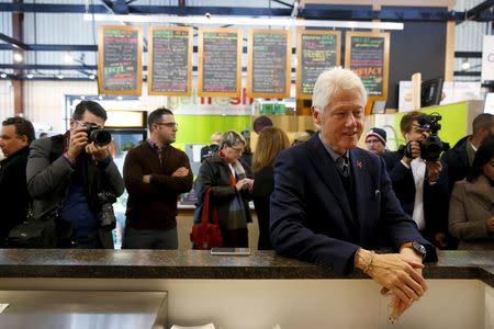 Former U.S. President Bill Clinton greets customers and employees while campaigning for his wife, Democratic presidential candidate Hillary Clinton, at the NewBo Market in Cedar Rapids, Iowa in this January 7, 2016 file photo. REUTERS/Aaron P. Bernstein/Files