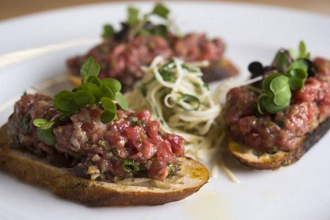 Steak tartare has capers and cornichons that brighten, and egg yolk that enriches, the raw meat, set atop crostini crisped at the edges but softened by olive oil in its middle.