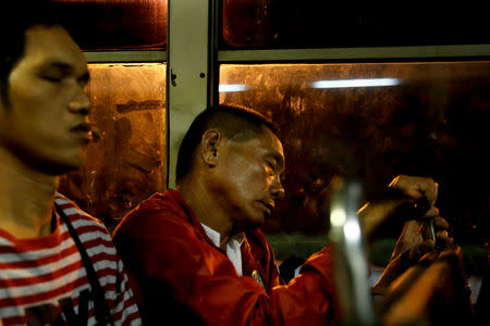 Alejandro Galasao, 58, street sweeper, sleeps on a bus in San Jose Del Monte City, Bulacan province, Philippines, November 15, 2018. Galasao usually sleeps on the bus going to work, as he only gets four to five hours of sleep each day. "To be honest, there's really not enough time to sleep. The earliest time I get to sleep is 20:00, sometimes 21:00 and then I have to wake up at 01:00" REUTERS/Eloisa Lopez