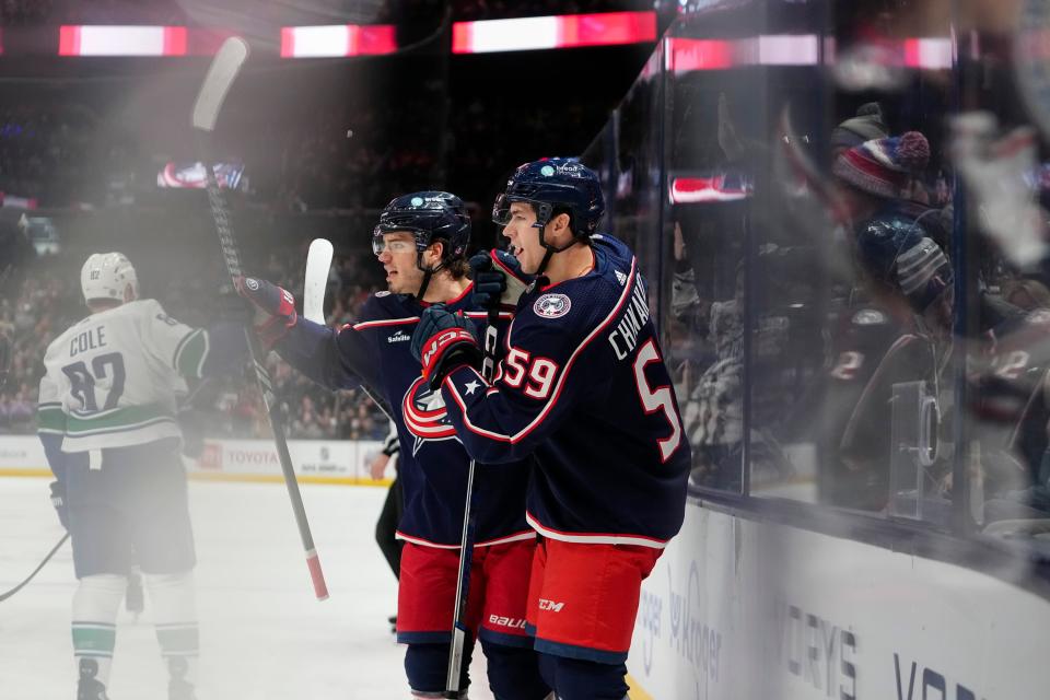 Jan 15, 2024; Columbus, Ohio, USA; Columbus Blue Jackets right wing Yegor Chinakhov (59) celebrates a goal with center Cole Sillinger (4) during the first period of the NHL hockey game against the Vancouver Canucks at Nationwide Arena.