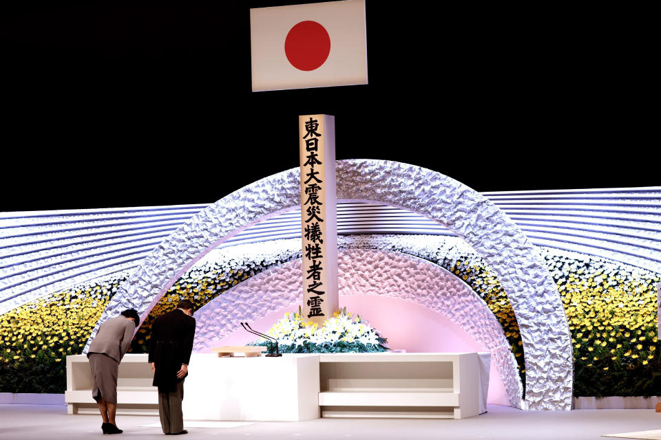 Japan's Emperor Naruhito, right, and Empress Masako bow in front of the altar for victims of the March 11, 2011 earthquake and tsunami at the national memorial service in Tokyo, Thursday, March 11, 2021. Japan is marking the 10th anniversary of the earthquake, tsunami and nuclear disaster with many survivors’ lives are still on hold. (Behrouz Mehri/Pool Photo via AP)