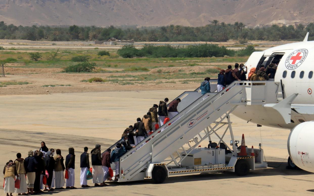 Houthi prisoners board a plane at Sayoun airport, Yemen, to be flown to Sanaa after being freed by the Saudi-led military coalition - Reuters