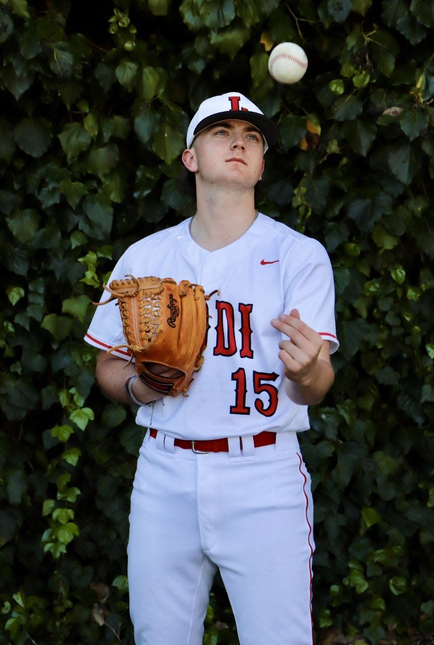 Andrew Wright, senior pitcher for Lodi throws the balls up during a photo shoot during the 2022-23 season.