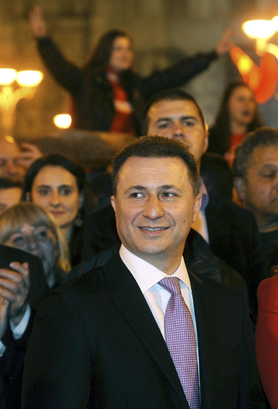 Macedonian Prime Minister and leader of the ruling conservative VMRO-DPMNE Nikola Gruevski, center, attends a celebration of the party's double victory in parliamentary and presidential elections, in downtown Skopje, Macedonia, early Monday, April 28, 2014. Macedonia's incumbent prime minister claimed a landslide victory late Sunday in parliamentary and presidential elections, but the center-left opposition denounced what it called distorting interference in the democratic process by the ruling party and said it won't recognize the results. (AP Photo/Boris Grdanoski)