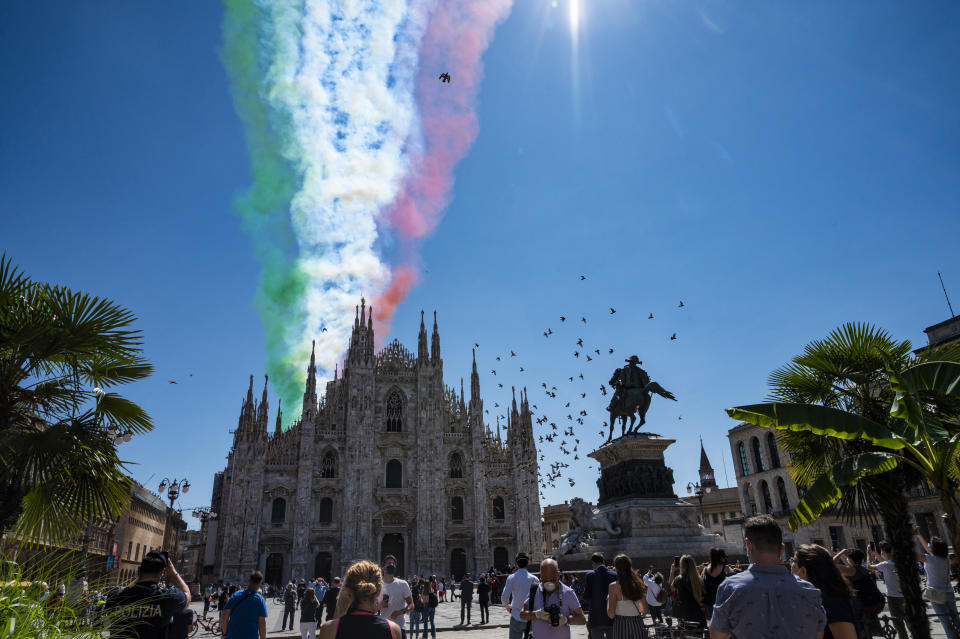 MILAN, ITALY - MAY 25: The Italian national aerobatic team, the Frecce Tricolore, flies over the Piazza Duomo of Milan on May 25, 2020 in Milan, Italy. Restaurants, bars, cafes, hairdressers and other shops have reopened, subject to social distancing measures, after more than two months of a nationwide lockdown meant to curb the spread of Covid-19.