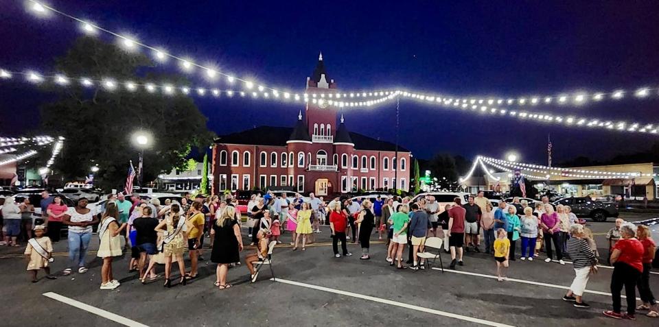 A large crowd gathers on Court Avenue in Elba, Alabama, on June 29, 2023, in anticipation of the marquee lighting ceremony at the Elba Theatre.