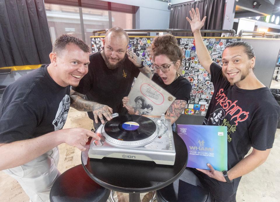 Quonset Hut co-owner Matt Hisrich, far left, Josh Brewer, owner of The Auricle, Sam Heaton, owner of Erie St Vinyl, and Kyle Laudermilt, Quonset Hut's vinyl buyer, pose with albums at The Auricle, where Vinyl Revival: Stark County's Record Swap & Shop event will be on Saturday in downtown Canton.