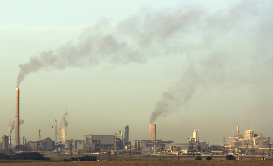 Smoke billows from the chimneys at Sasol Plant, a plant that produces petrol and diesel from coal, in Sasolburg, South Africa, Tuesday, Dec. 4, 2018. The two-week U.N. climate meeting in Poland is intended to finalize details of the 2015 Paris accord on keeping average global temperature increases well below 2 degrees Celsius (3.6 Fahrenheit). (AP Photo/Themba Hadebe)