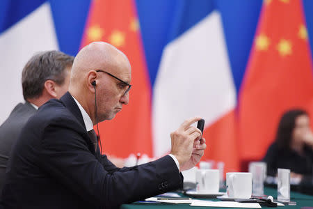 Danone Asia Chairman, Pascal de Petrini, takes a photo during a meeting of French business leaders and entrepreneurs with Chinese Premier Li Keqiang and French Prime Minister Edouard Philippe at the Great Hall of the People in Beijing, China June 25, 2018. Greg Baker/Pool via REUTERS