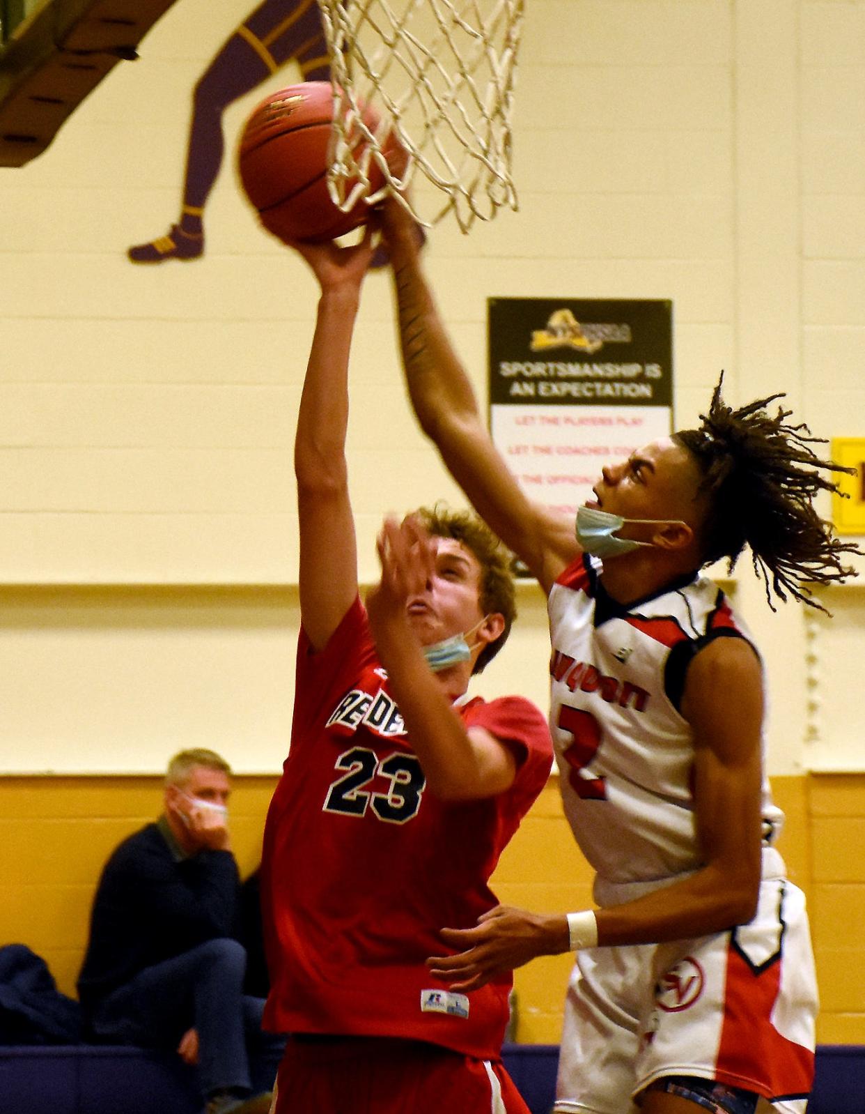 Sauquoit Valley Indian Donovan Nelson (left) blocks a shot by Vernon-Verona-Sherrill Red Devil Elijah Donegan (23) Saturday during the Richfield Springs Indians Tip-off Tournament championship game.