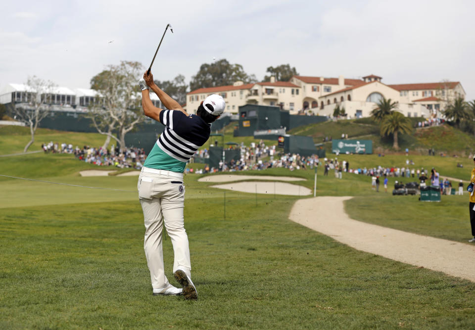 Sang-Moon Bae, of South Korea, makes his approach from the rough to the ninth green during the third round of the Northern Trust Open golf tournament at Riviera Country Club in the Pacific Palisades area of Los Angeles Saturday, Feb. 15, 2014. (AP Photo/Reed Saxon)