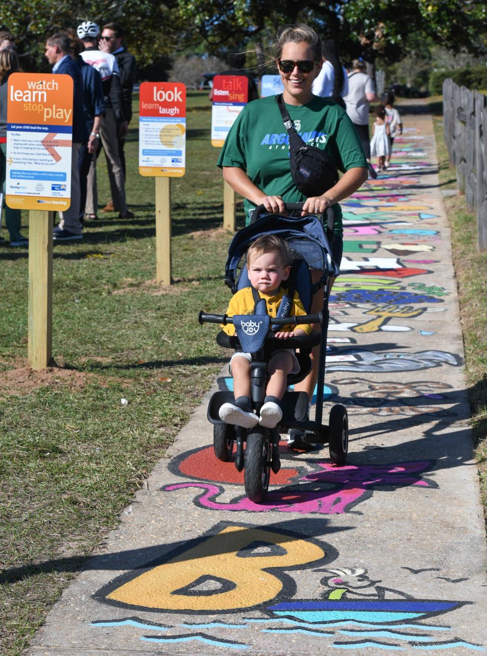 Hannah Kessler pushes her 15-month-old son Fitz down the new Born Learning Trail at Bayview Park in Pensacola on Tuesday, Oct. 24, 2023. This newest Born Learning Trail was created by the Pensacola News Journal in association with Ready Kids!, the United Way of West Florida, and the Sunstone Project.