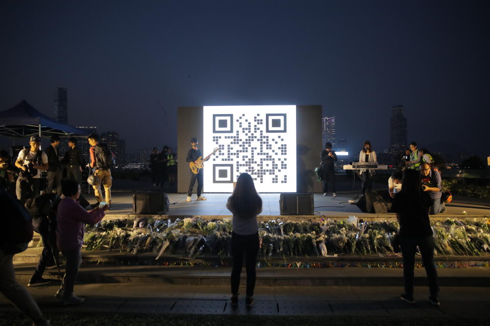 People attend a vigil for student Chow Tsz-Lok in Hong Kong, Saturday, Nov. 9, 2019. Chow Tsz-Lok, the Hong Kong university student who fell off a parking garage after police fired tear gas during clashes with anti-government protesters died Friday in a rare fatality in five months of unrest, fueling more outrage against authorities in the semi-autonomous Chinese territory. (AP Photo/Kin Cheung)