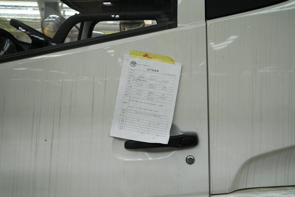A production task sheet is sticked on a liquid tanker truck at a Yizhuan Automobile Co. manufacturing factory during a media-organized tour in Shiyan city in central China's Hubei Province on May 12, 2023. China's manufacturing and consumer spending are weakening after a strong start to 2023 after anti-virus controls ended. (AP Photo/Andy Wong)